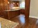 Bright kitchen features a large island with cooktop, granite countertops, custom cabinetry and hardwood floors at 870 Thornberry Dr, Alpharetta, GA 30022