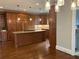 Spacious kitchen with dark wood cabinets, granite counters, and a large center island with cooktop at 870 Thornberry Dr, Alpharetta, GA 30022
