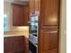 Kitchen featuring granite countertops, custom wood cabinets, stainless steel appliances, and tile backsplash at 870 Thornberry Dr, Alpharetta, GA 30022