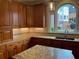 Bright kitchen with granite countertops, custom wood cabinets, stainless sink and a large window at 870 Thornberry Dr, Alpharetta, GA 30022