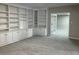 Spacious living room features custom built-in shelving and grey carpet at 870 Thornberry Dr, Alpharetta, GA 30022