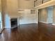Spacious living room featuring a fireplace, built-in shelving, and hardwood floors at 870 Thornberry Dr, Alpharetta, GA 30022