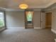 Main bedroom featuring tray ceilings, neutral carpet, and view to ensuite bath at 870 Thornberry Dr, Alpharetta, GA 30022