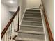 Carpeted staircase featuring a stained wood handrail and white spindles, leading to the upper level at 870 Thornberry Dr, Alpharetta, GA 30022