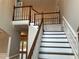 Elegant staircase featuring white risers, wood treads, and a beautifully crafted banister leading to the upper level at 870 Thornberry Dr, Alpharetta, GA 30022