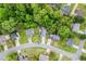 Aerial view of the property highlighting the surrounding neighborhood, mature trees, and community streets at 1029 Megan Ct, Sugar Hill, GA 30518