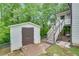 Fenced backyard featuring an outdoor shed and stairs to an upper floor porch at 1029 Megan Ct, Sugar Hill, GA 30518