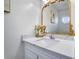 Elegant powder room boasts a marble countertop, decorative mirror, and stylish fixtures at 1029 Megan Ct, Sugar Hill, GA 30518