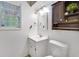 Bright bathroom featuring a single vanity, mirror, and decorative lighting fixtures at 1029 Megan Ct, Sugar Hill, GA 30518
