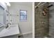 Tiled shower, window, and vanity sink in renovated bathroom at 1029 Megan Ct, Sugar Hill, GA 30518