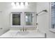 Bright bathroom with marble countertop vanity with modern fixtures and mirrors at 1029 Megan Ct, Sugar Hill, GA 30518