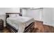 Bedroom featuring hardwood floors, a large bed with storage, and a closet at 1029 Megan Ct, Sugar Hill, GA 30518
