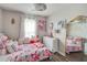 Pink themed bedroom with chandelier lighting and a playful, decorative style at 1029 Megan Ct, Sugar Hill, GA 30518