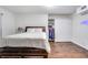 Bedroom featuring hardwood floors, a large bed with storage, and a closet at 1029 Megan Ct, Sugar Hill, GA 30518