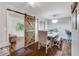 Elegant dining room showcases a sliding barn door, stylish furniture, and modern lighting fixtures at 1029 Megan Ct, Sugar Hill, GA 30518