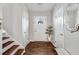 Bright foyer features hardwood floors, staircase, and a decorative mirror creating an inviting entry at 1029 Megan Ct, Sugar Hill, GA 30518