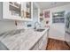 Bright white kitchen featuring quartz countertops, stainless appliances, and ample storage at 1029 Megan Ct, Sugar Hill, GA 30518