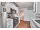 Updated kitchen features stainless appliances, white cabinets, and quartz counters at 1029 Megan Ct, Sugar Hill, GA 30518