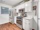 Bright kitchen features stainless appliances, white cabinets, and quartz counters at 1029 Megan Ct, Sugar Hill, GA 30518
