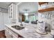 Bright white kitchen featuring quartz countertops, stainless sink, and coffee bar at 1029 Megan Ct, Sugar Hill, GA 30518