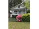 Charming home featuring a cozy front porch, surrounded by lush greenery and vibrant flowers, creating a welcoming curb appeal at 1311 Sylvan Cir, Brookhaven, GA 30319