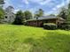 View of the back of the home showing a large green backyard at 2988 Ramble Ln, Decatur, GA 30033