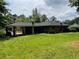 Back exterior view of the home, featuring a large backyard at 2988 Ramble Ln, Decatur, GA 30033