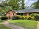 Charming single-story brick home features a walkway and lush landscaping at 2988 Ramble Ln, Decatur, GA 30033