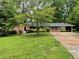 Charming single-story home with a well-manicured lawn and mature shade tree at 2988 Ramble Ln, Decatur, GA 30033