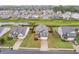 Aerial view of a suburban neighborhood featuring well-manicured lawns and diverse home styles near a pond at 59 Summer Nw Pl, Cartersville, GA 30121