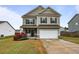 Charming two-story home with a well-manicured lawn, inviting porch, and attached garage at 59 Summer Nw Pl, Cartersville, GA 30121