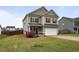 Two-story home with tan siding, trimmed windows, a manicured lawn, and a two car attached garage at 59 Summer Nw Pl, Cartersville, GA 30121
