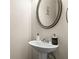 Powder room with pedestal sink, large mirror and tiled floor at 59 Summer Nw Pl, Cartersville, GA 30121
