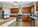 Modern kitchen featuring wood cabinets, granite countertops, stainless steel appliances, and a functional island at 59 Summer Nw Pl, Cartersville, GA 30121