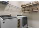 Efficient laundry room featuring a modern washer and dryer set with shelving and storage baskets for organization at 59 Summer Nw Pl, Cartersville, GA 30121