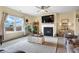 Sunlit living room features a cozy fireplace and a view of the outdoors, creating a warm and inviting atmosphere at 59 Summer Nw Pl, Cartersville, GA 30121