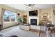 Inviting living room featuring a fireplace with mounted television, ceiling fan, and large window at 59 Summer Nw Pl, Cartersville, GA 30121