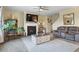 Bright living room with fireplace, ceiling fan, large area rug, and lots of natural light at 59 Summer Nw Pl, Cartersville, GA 30121