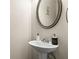 Elegant powder room showcasing a pedestal sink, decorative mirror, and stylish accessories at 59 Summer Nw Pl, Cartersville, GA 30121