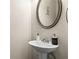 Stylish powder room featuring a pedestal sink, modern fixtures, and a decorative mirror at 59 Summer Nw Pl, Cartersville, GA 30121