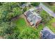 Aerial view of home's backyard featuring a wooden deck, patio, and mature trees at 1885 Vintage Dr, Snellville, GA 30078