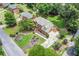 Charming home with a manicured lawn, driveway, lush greenery, and nearby homes at 1885 Vintage Dr, Snellville, GA 30078