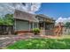 Large backyard showcasing a screened porch, brick patio, and mature trees at 1885 Vintage Dr, Snellville, GA 30078