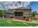 Scenic backyard with a screened porch, wooden deck, and ample green space at 1885 Vintage Dr, Snellville, GA 30078