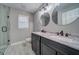 Modern bathroom showcasing dual sinks, large mirrors, a glass shower, and tile flooring at 1885 Vintage Dr, Snellville, GA 30078