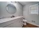 Bathroom featuring hardwood floors, grey vanity with light marble countertop, and modern fixtures at 1885 Vintage Dr, Snellville, GA 30078