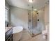 Bright bathroom featuring a glass-enclosed shower and soaking tub at 1885 Vintage Dr, Snellville, GA 30078
