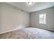 Bright bedroom with neutral carpeting, light gray walls and a window at 1885 Vintage Dr, Snellville, GA 30078