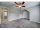 Spacious bedroom featuring plush carpet, ceiling fan, walk in closet and a gray paint scheme at 1885 Vintage Dr, Snellville, GA 30078