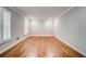 Bedroom features hardwood floors, light gray walls, and bright natural light at 1885 Vintage Dr, Snellville, GA 30078